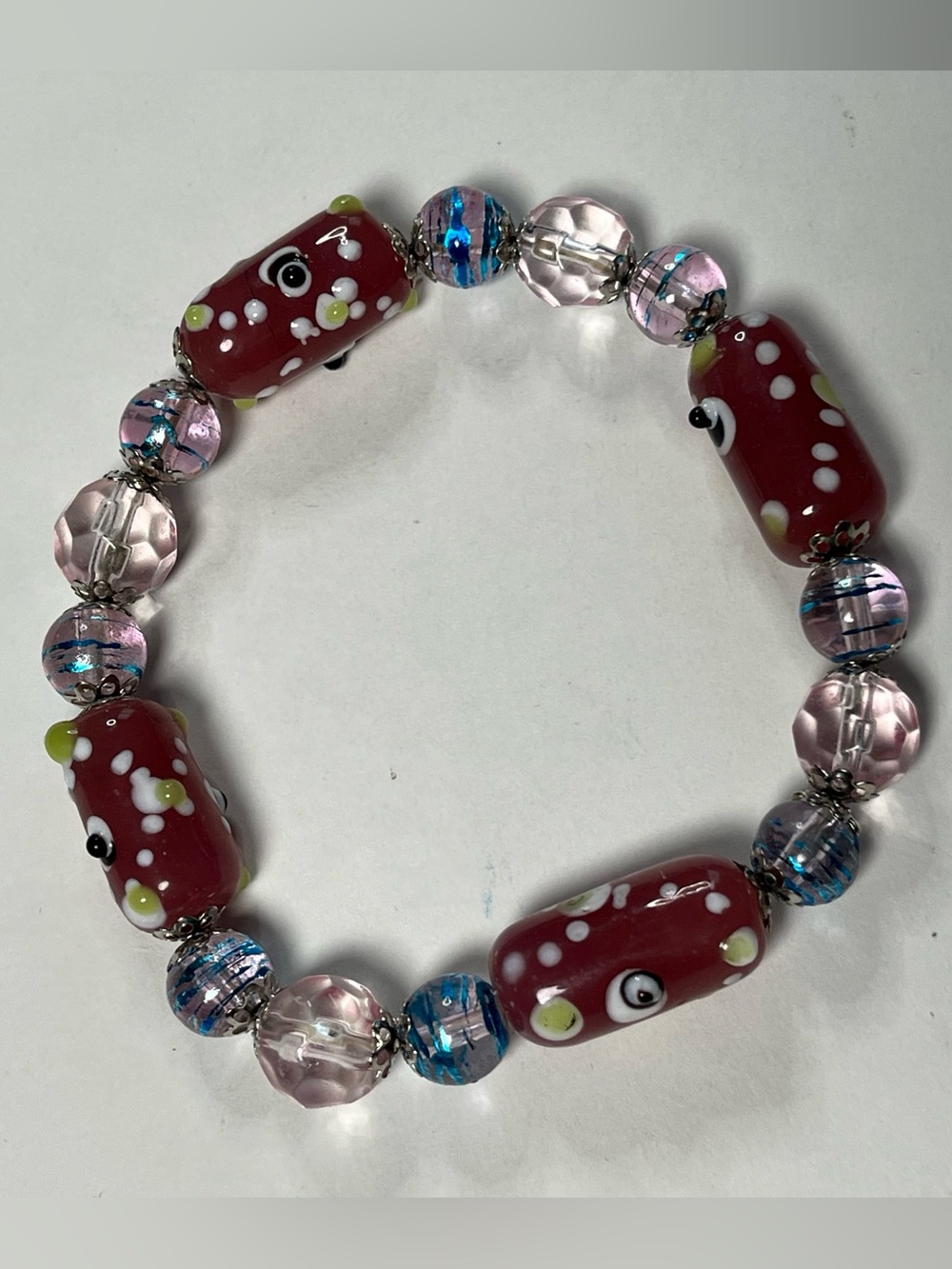 NWOT beautiful bead bracelet strung on elastic. The beads are taupe,blue & clear